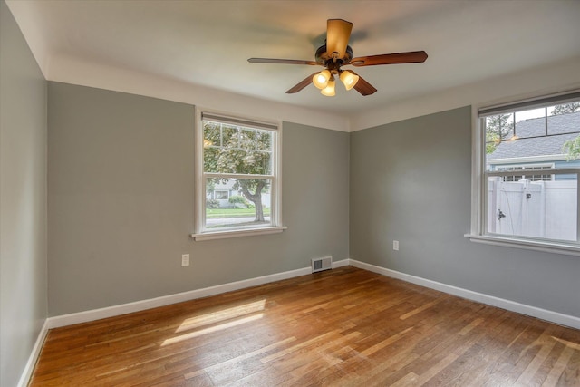 2410 W Upton Ave, Spokane, WA 99205 - spare room with hardwood / wood-style flooring, a ceiling fan, and baseboards