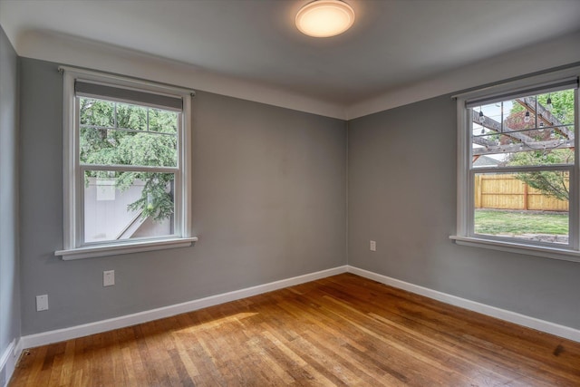 2410 W Upton Ave, Spokane, WA 99205 - spare room featuring hardwood / wood-style floors, baseboards, and healthy amount of natural light