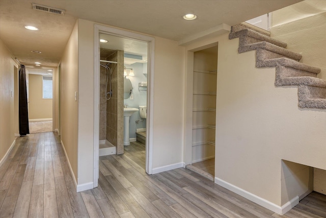 2410 W Upton Ave, Spokane, WA 99205 - hallway featuring wood finished floors, baseboards, stairway, and recessed lighting