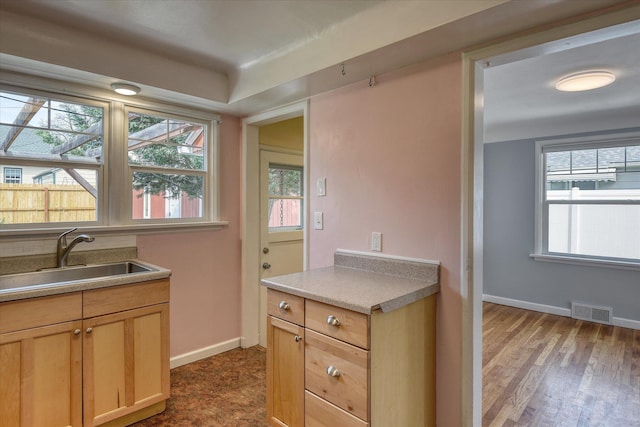 2410 W Upton Ave, Spokane, WA 99205 - kitchen with a sink, baseboards, and wood finished floors