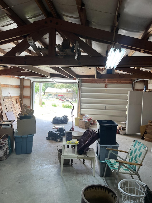 309 S Coal Creek Rd, Harrington, WA 99134 - garage with freestanding refrigerator and a garage door opener