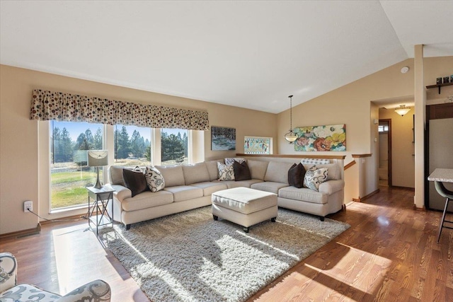 17206 W Buckboard Ave, Medical Lake, WA 99022 - living room with plenty of natural light, vaulted ceiling, wood finished floors, and baseboards