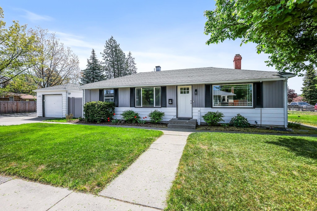 4117 W Wellesley Ave, Spokane, WA 99205 - ranch-style house featuring a chimney, concrete driveway, entry steps, and roof with shingles