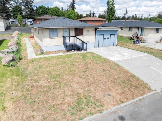 1514 3rd St, Cheney, WA 99004 - ranch-style house featuring brick siding, driveway, entry steps, and a shingled roof