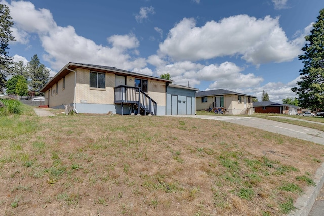 1514 3rd St, Cheney, WA 99004 - ranch-style house with brick siding, concrete driveway, and a garage