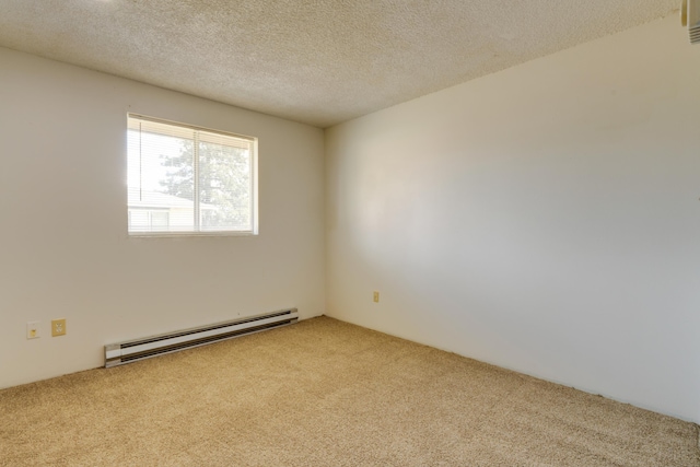 1514 3rd St, Cheney, WA 99004 - spare room featuring a baseboard heating unit, carpet flooring, and a textured ceiling