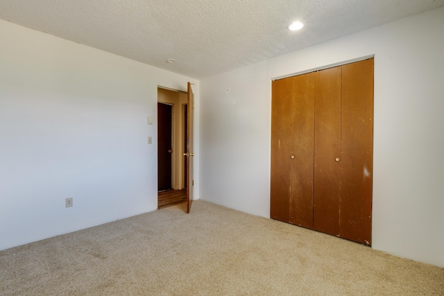 1514 3rd St, Cheney, WA 99004 - unfurnished bedroom with carpet flooring, a closet, a textured ceiling, and recessed lighting