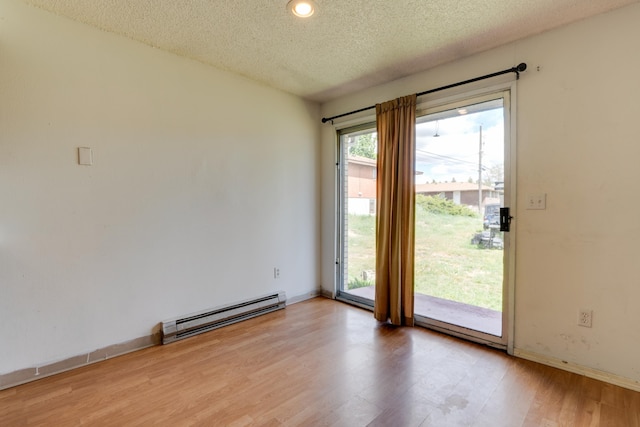 1514 3rd St, Cheney, WA 99004 - unfurnished room with a baseboard radiator, light wood finished floors, a textured ceiling, baseboards, and recessed lighting