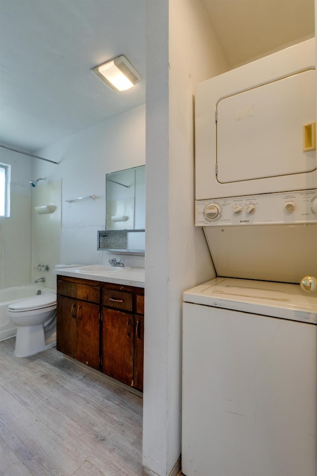 1514 3rd St, Cheney, WA 99004 - washroom with stacked washer and clothes dryer and light wood-style floors
