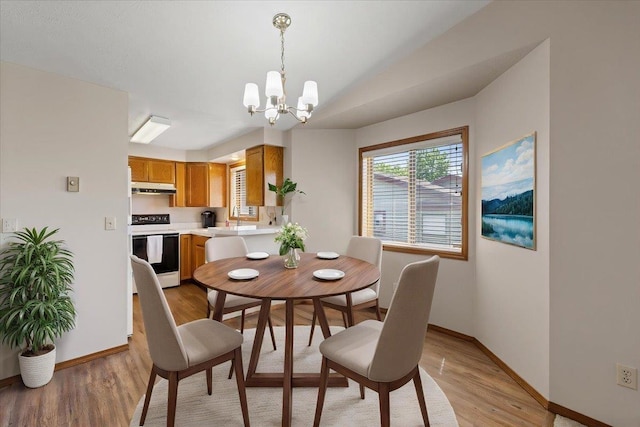 3716 S Alder Cir, Spokane, WA 99223 - dining space featuring a chandelier, baseboards, light wood-type flooring, and lofted ceiling