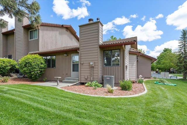 3716 S Alder Cir, Spokane, WA 99223 - back of property featuring a chimney, a lawn, and central AC
