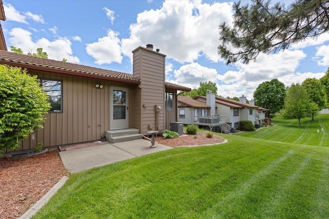 3716 S Alder Cir, Spokane, WA 99223 - rear view of property featuring a chimney, central air condition unit, a yard, a patio, and board and batten siding