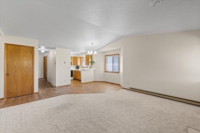 3716 S Alder Cir, Spokane, WA 99223 - unfurnished living room featuring a chandelier, vaulted ceiling, baseboards, a baseboard heating unit, and light wood-style flooring
