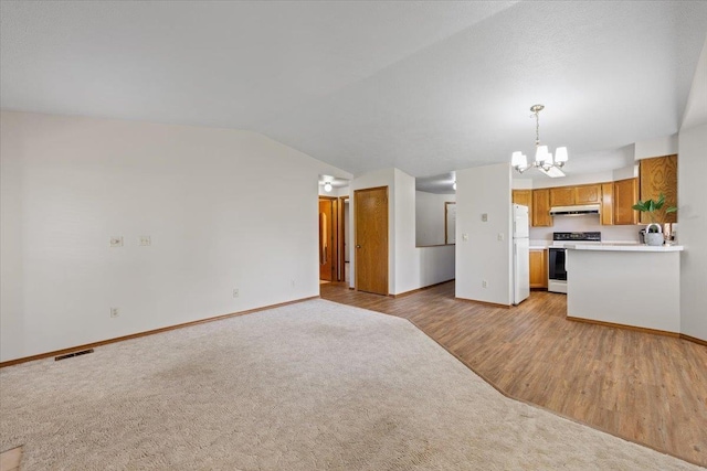 3716 S Alder Cir, Spokane, WA 99223 - kitchen with electric stove, a chandelier, baseboards, brown cabinets, and lofted ceiling