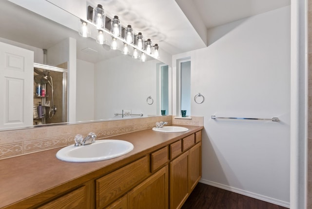 3022 E Pineglen Ave, Mead, WA 99021 - bathroom with a stall shower, double vanity, wood finished floors, and baseboards