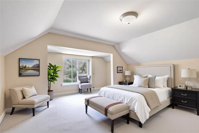 bedroom with lofted ceiling, light carpet, and baseboards