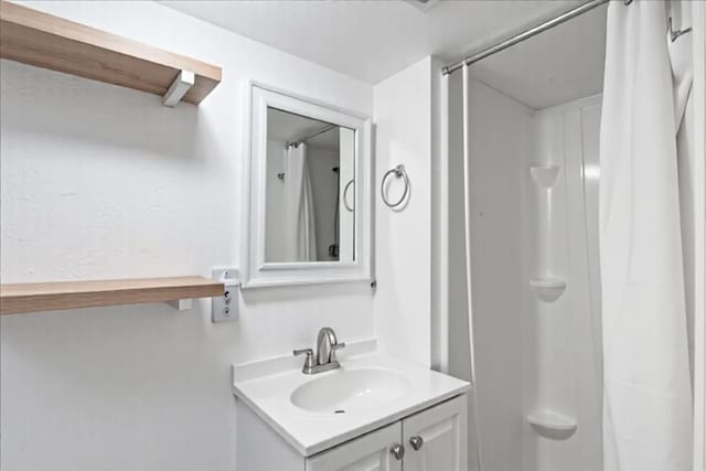 bathroom with vanity and a shower with shower curtain