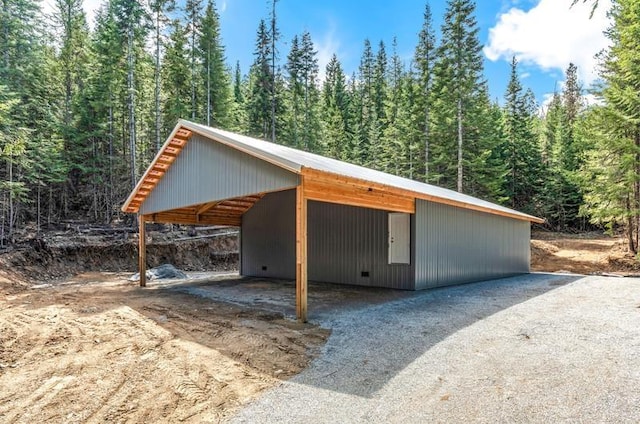 4821 Coyote Trl, Newport, WA 99156 - view of outbuilding featuring a view of trees, dirt driveway, and an outdoor structure