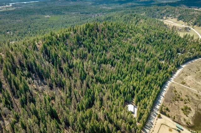 4821 Coyote Trl, Newport, WA 99156 - aerial view of property and surrounding area featuring a heavily wooded area and mountains