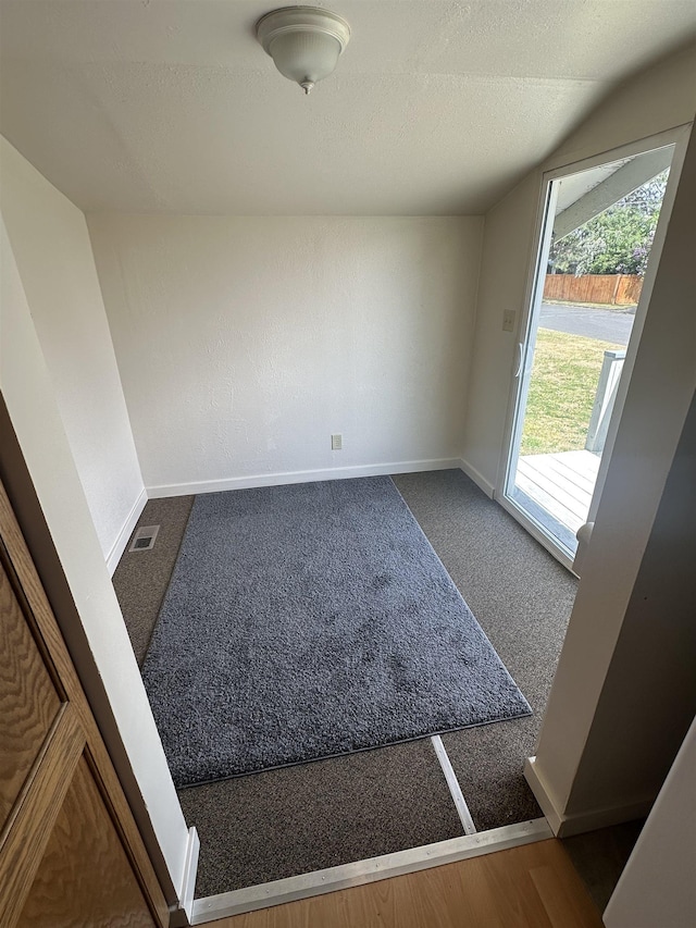 2304 W Glass St, Spokane, WA 99205 - carpeted empty room featuring a textured ceiling, baseboards, and vaulted ceiling