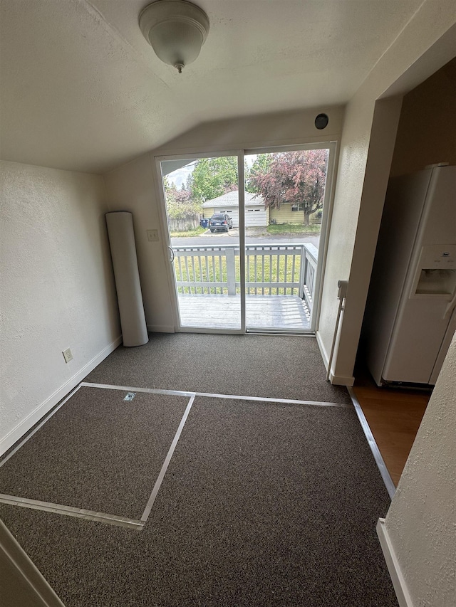 2304 W Glass St, Spokane, WA 99205 - unfurnished living room featuring lofted ceiling, baseboards, a textured wall, and carpet flooring