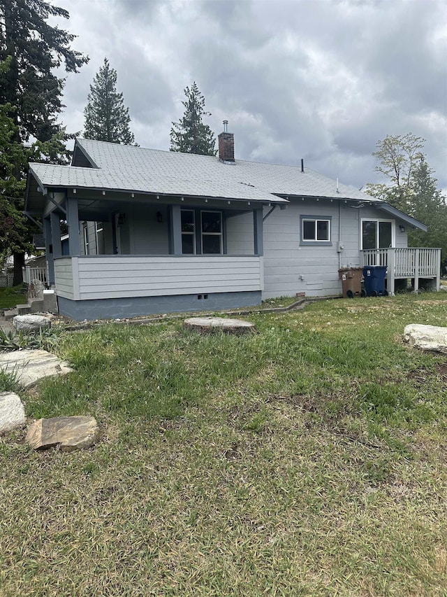 2304 W Glass St, Spokane, WA 99205 - rear view of house with a chimney, a yard, a deck, and crawl space