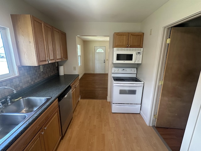 2304 W Glass St, Spokane, WA 99205 - kitchen with white appliances, a sink, light wood finished floors, and plenty of natural light