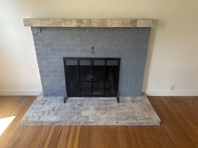 2304 W Glass St, Spokane, WA 99205 - detailed view of wood finished floors, baseboards, and a fireplace with raised hearth