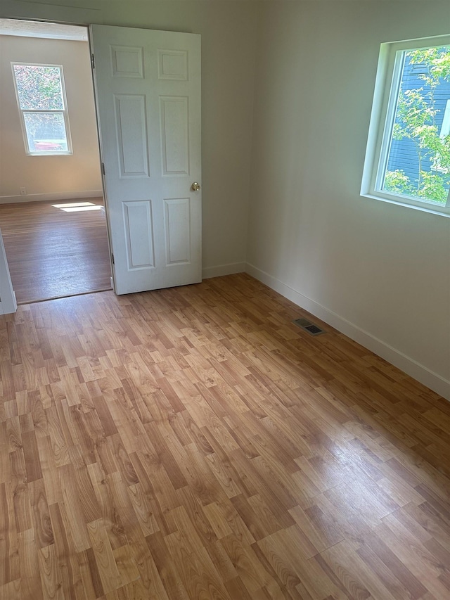 2304 W Glass St, Spokane, WA 99205 - unfurnished bedroom with baseboards, multiple windows, and light wood finished floors