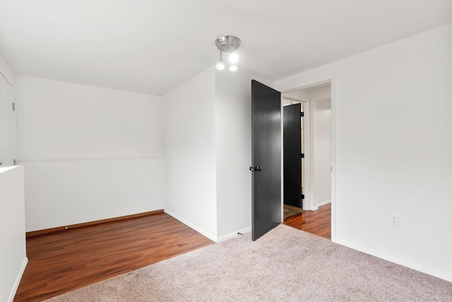 2612 E Longfellow Ave, Spokane, WA 99207 - carpeted spare room with baseboards and wood finished floors