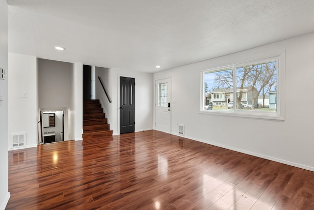 2612 E Longfellow Ave, Spokane, WA 99207 - unfurnished living room featuring stairs, wood finished floors, recessed lighting, and baseboards