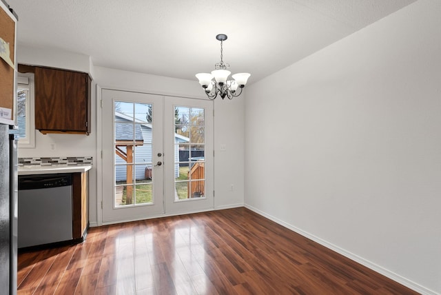 2612 E Longfellow Ave, Spokane, WA 99207 - unfurnished dining area featuring dark wood-style floors, a chandelier, french doors, and baseboards