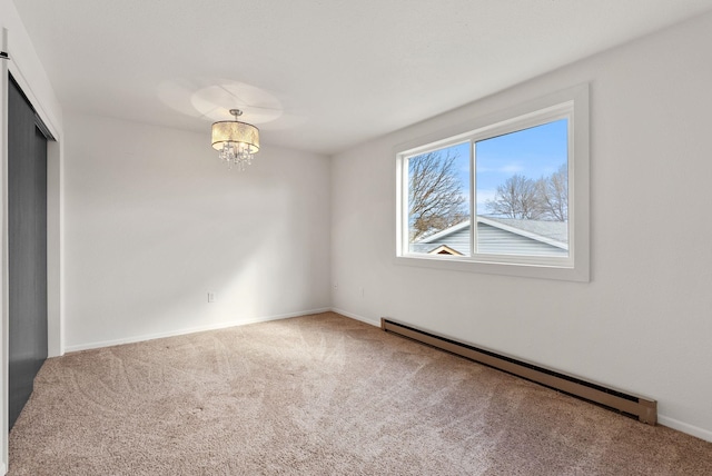 2612 E Longfellow Ave, Spokane, WA 99207 - spare room with a baseboard heating unit, carpet, a chandelier, and baseboards