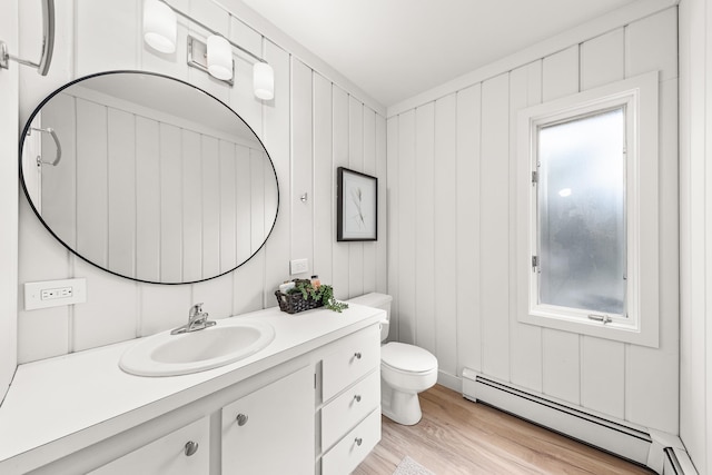 2127 S Helena St, Spokane, WA 99203 - bathroom featuring a baseboard heating unit, wood finished floors, vanity, and toilet