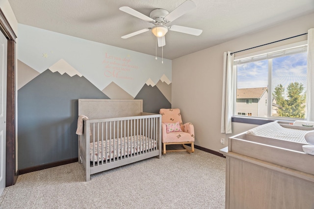9414 W Ballesteros Ct, Cheney, WA 99004 - bedroom with light colored carpet, a nursery area, baseboards, and a ceiling fan