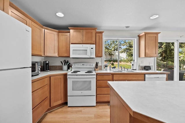1626 5th St, Cheney, WA 99004 - kitchen with white appliances, a sink, light countertops, light wood finished floors, and recessed lighting