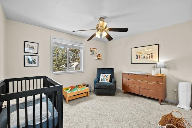 1626 5th St, Cheney, WA 99004 - bedroom with carpet floors, a crib, baseboards, and a ceiling fan