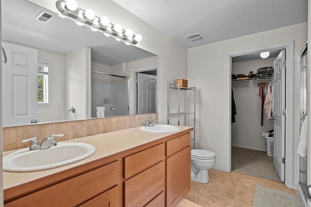 1626 5th St, Cheney, WA 99004 - full bathroom featuring a shower stall, double vanity, a walk in closet, and toilet