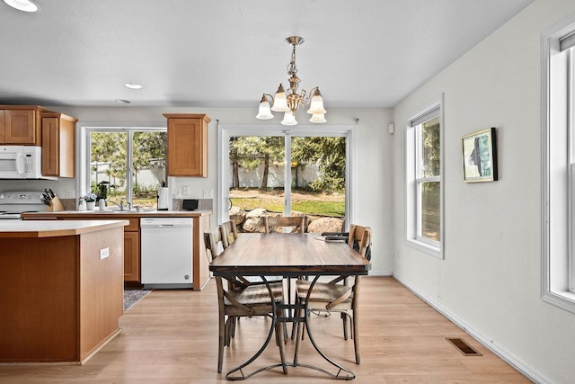 1626 5th St, Cheney, WA 99004 - dining space with light wood-type flooring, a chandelier, plenty of natural light, and recessed lighting