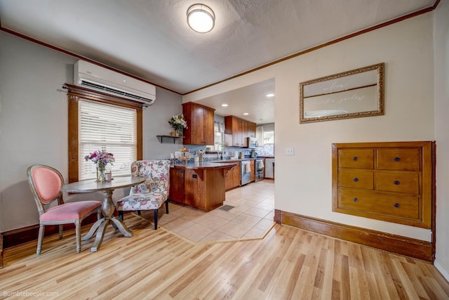 2117 E Gordon Ave, Spokane, WA 99207 - dining room with a wall mounted air conditioner, crown molding, light wood finished floors, and baseboards