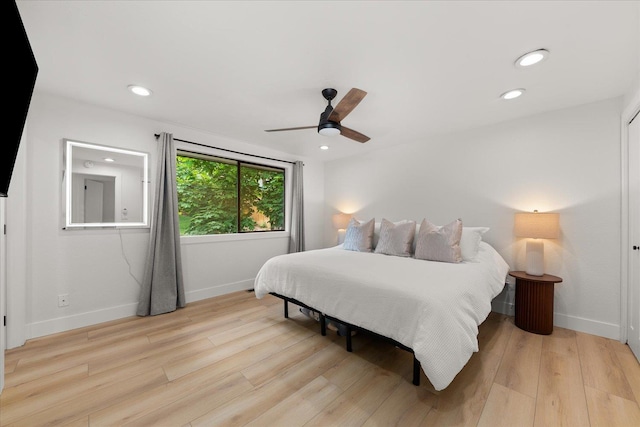 bedroom featuring baseboards, light wood-type flooring, recessed lighting, and a ceiling fan