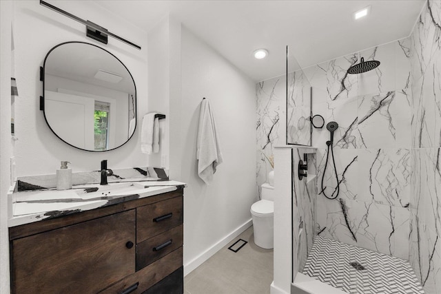bathroom with vanity, toilet, a marble finish shower, baseboards, and recessed lighting