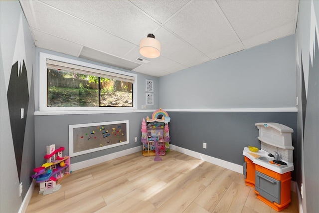game room featuring light wood-style flooring and baseboards