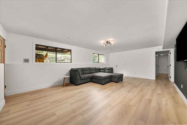 living room with light wood-type flooring and baseboards