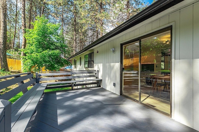 wooden terrace featuring fence