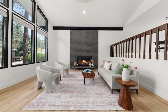 living room with vaulted ceiling, wood finished floors, baseboards, a brick fireplace, and recessed lighting