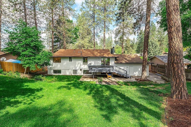 rear view of house featuring a wooden deck