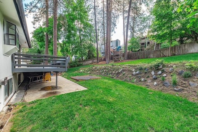 view of yard featuring a patio and a deck