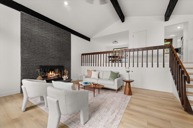 living area with light wood-type flooring, stairway, a fireplace, baseboards, and recessed lighting