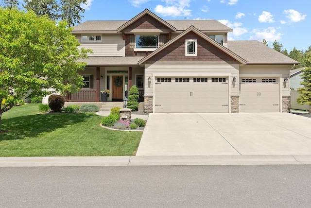craftsman-style home featuring an attached garage, stone siding, concrete driveway, a front yard, and a porch